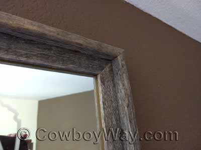 A barn wood frame holding a mirror