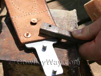 Using the copper rivet and burr setter tool to drive the burrs down to the bottom of the posts