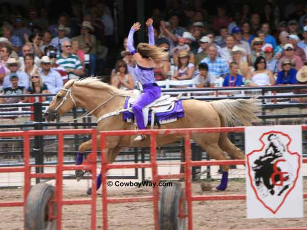 A trick rider waves good-bye to the crowd