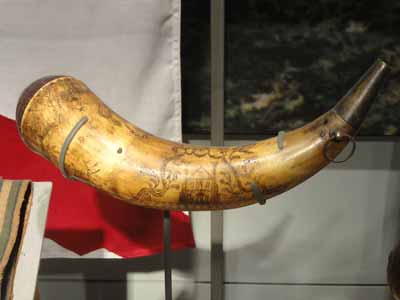 A carved horn from an animal skull