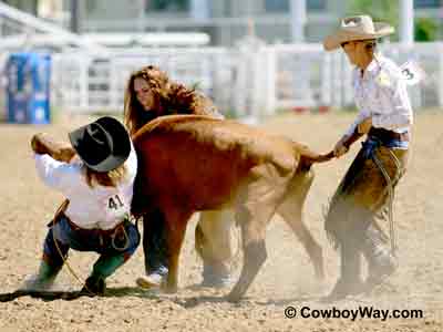 Picture of a cowgirl mugging a steer