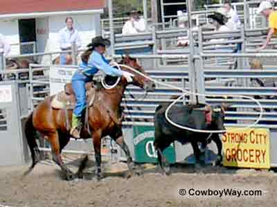 A cowgirl ropes a steer at a women's ranch rodeo