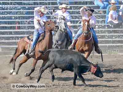 Three team members move in for the heel catch
