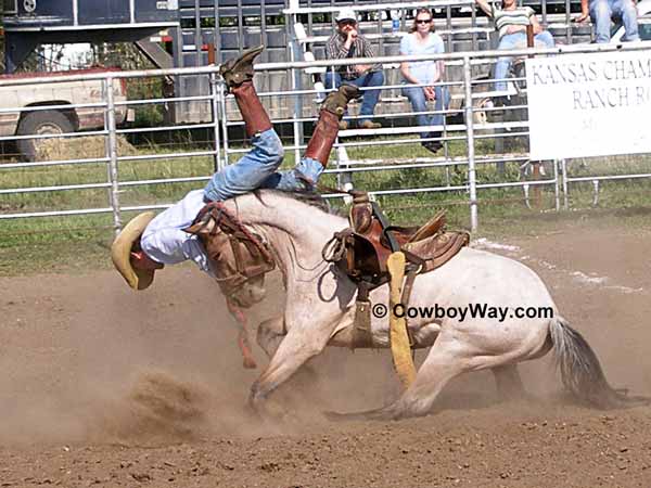 A bronc rider gets bucked off over the head of a horse