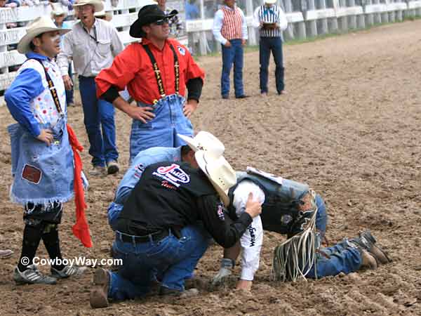 A bull rider gets help
