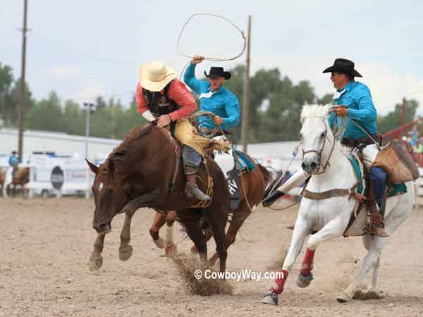 Pickup men move in after a bronc ride
