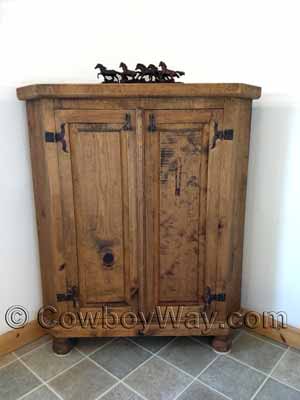 A bathroom with a rustic corner cabinet
