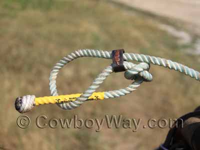 Tuck the tail of the rope through the loop so the horn knot won't slip off