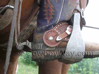 Spur straps and spurs on cowboy boots
